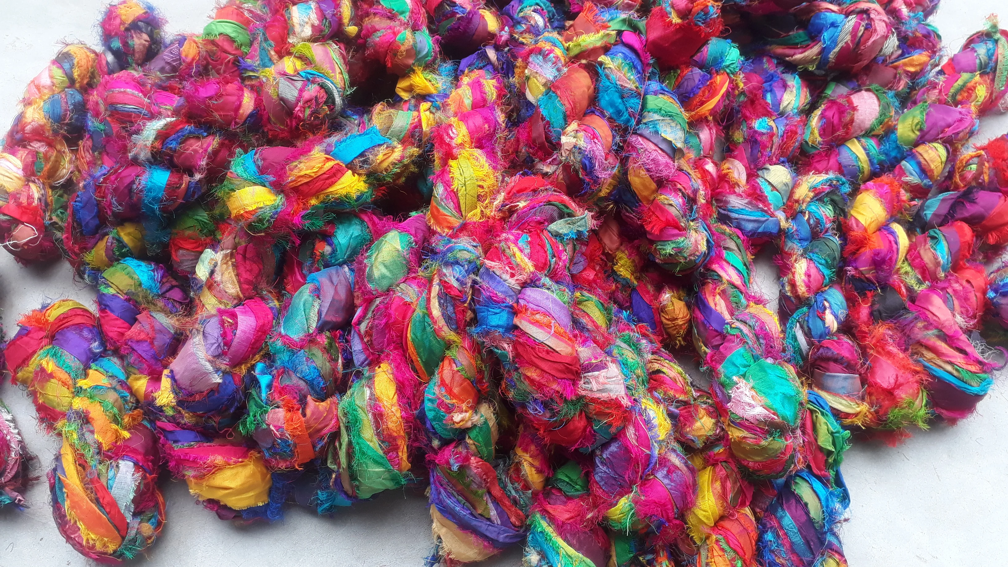 multi colored sari silk fuzzy  ribbon yarns made recycled sari fabrics ideal for textile artists and yarn stores for resale