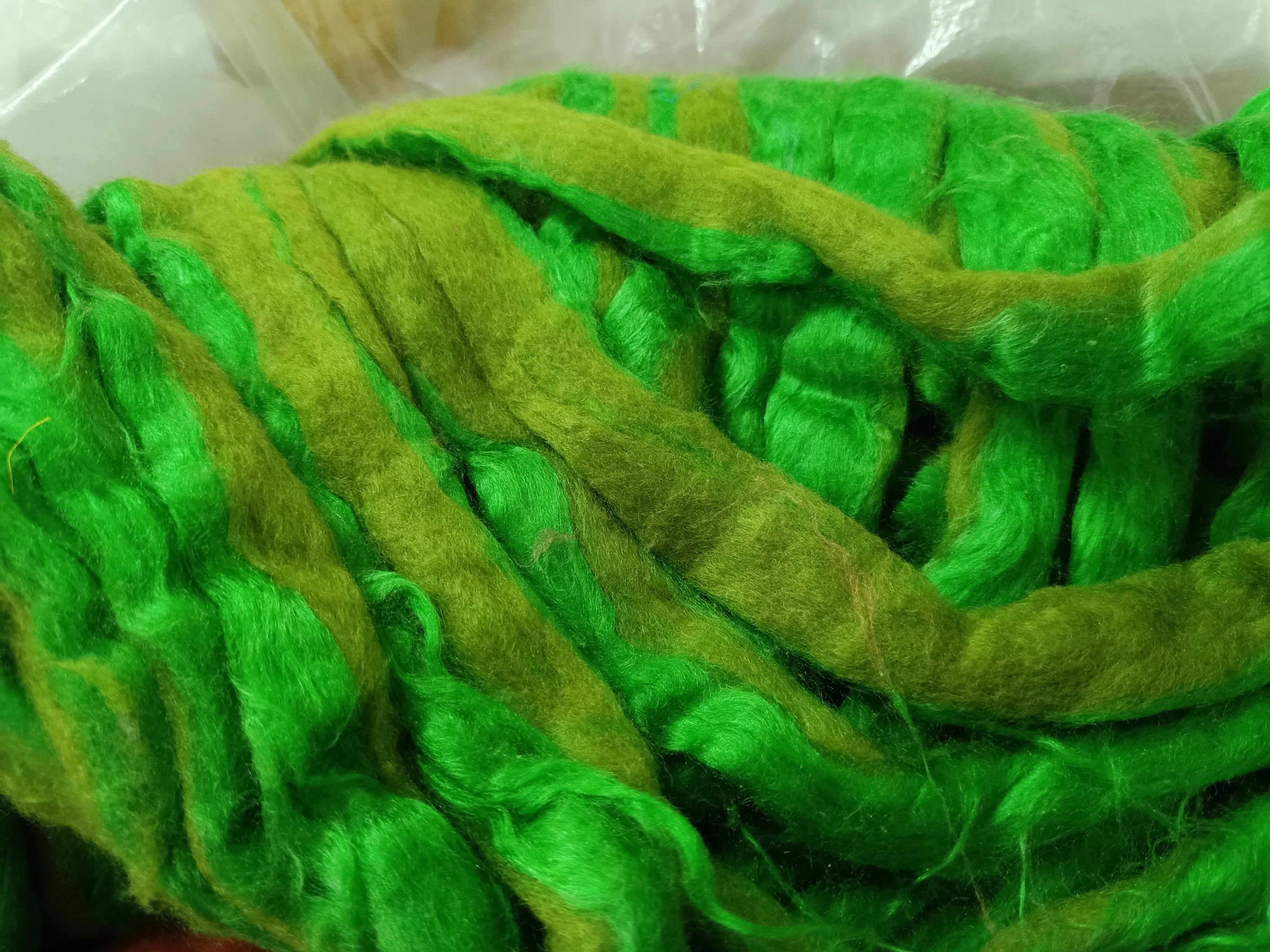 custom made bright green colored sari silk sliver made from the finest mulberry silk roving ideal for textile spinners