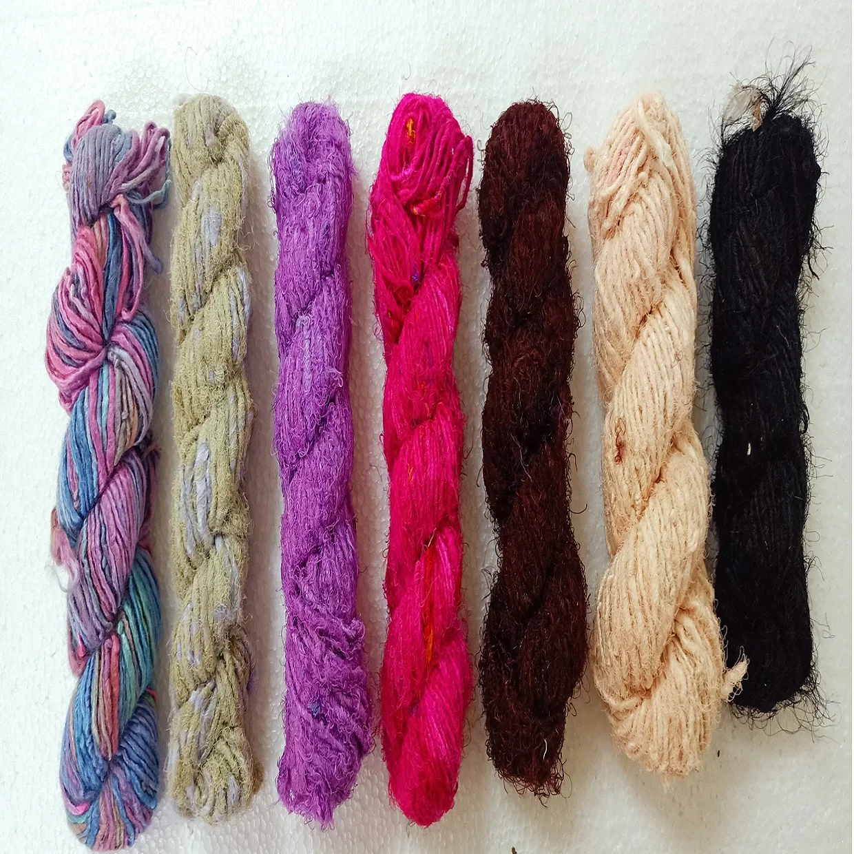 custom made natural and dyed banana an sari silk yarns made from recycled sari silk and banana silk fibers