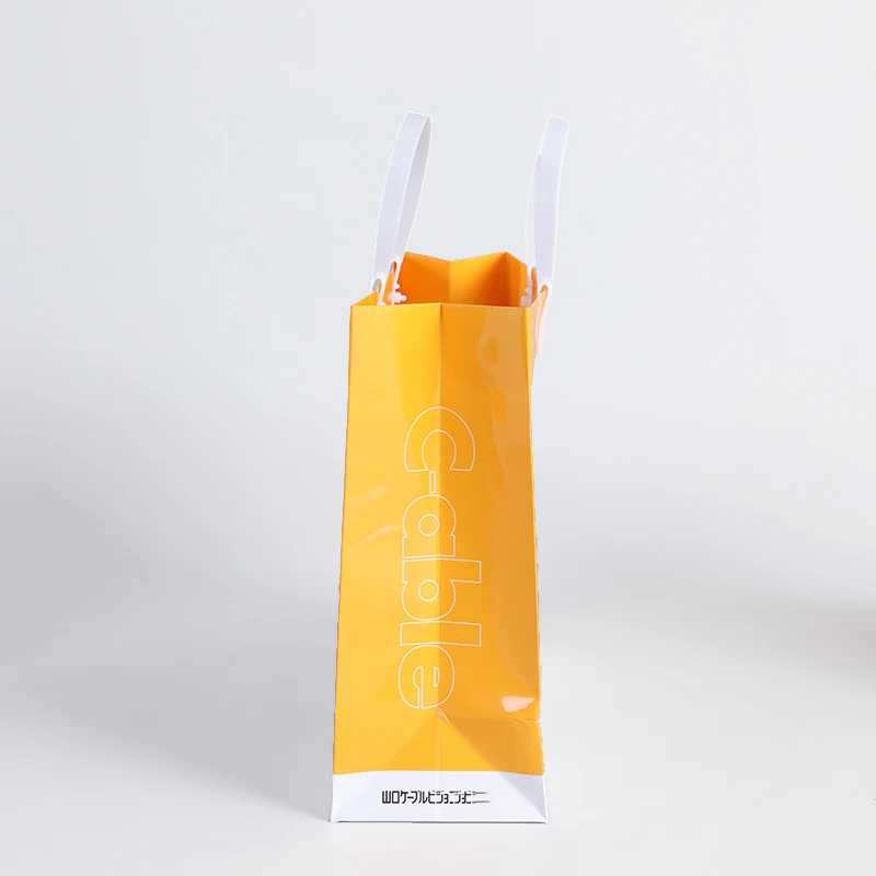 Customize machine making recyclable Orange cloth electronics pharmacy shopping carry paper bag with logo pvc handle