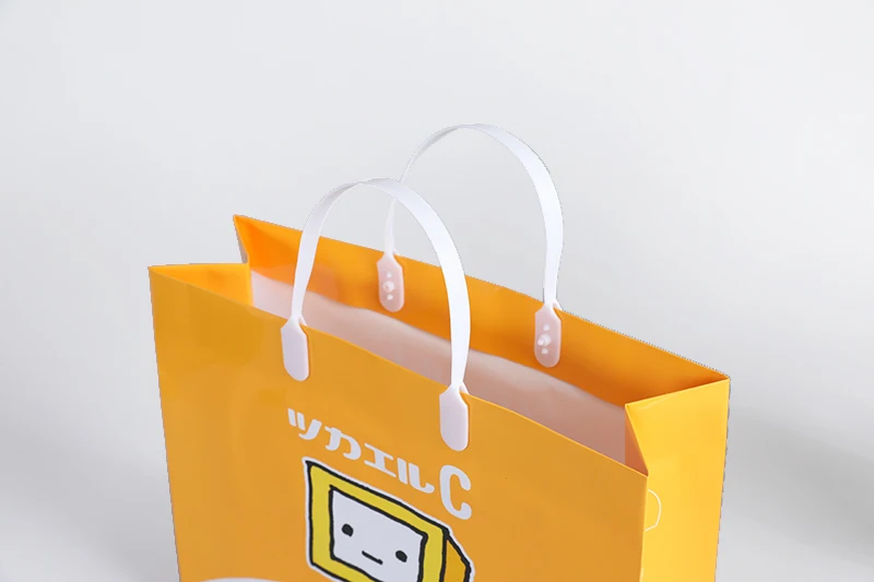 Customize machine making recyclable Orange cloth electronics pharmacy shopping carry paper bag with logo pvc handle