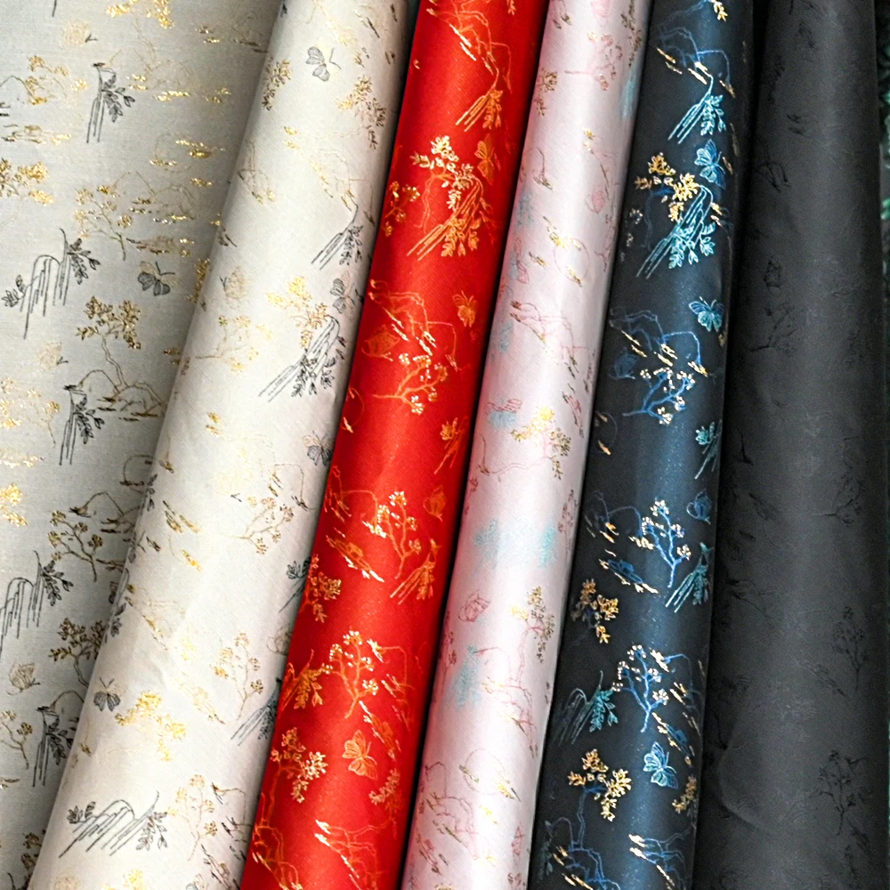 Yili Classical and exquisite gold floral and plant pattern fabric with red background and gold pattern elegant clothing fabric