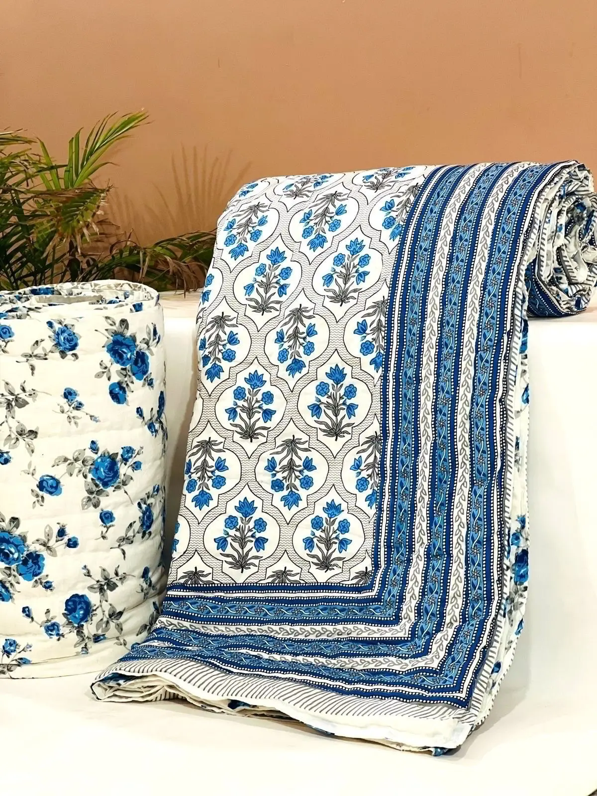 custom made 100% cotton quilts in different designs & various sizes on blue base fabric & multi colour print.