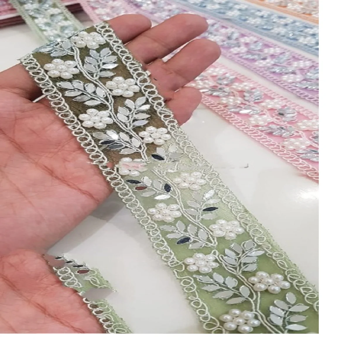 custom made machine embroidered ribbons & laces in various designs & colours for wedding dresses on net fabric with curly border