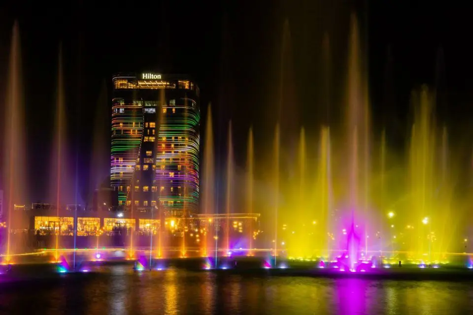 A large outdoor music and dancing water fountain show featuring laser lights, water screen mapping, video projections, fireworks