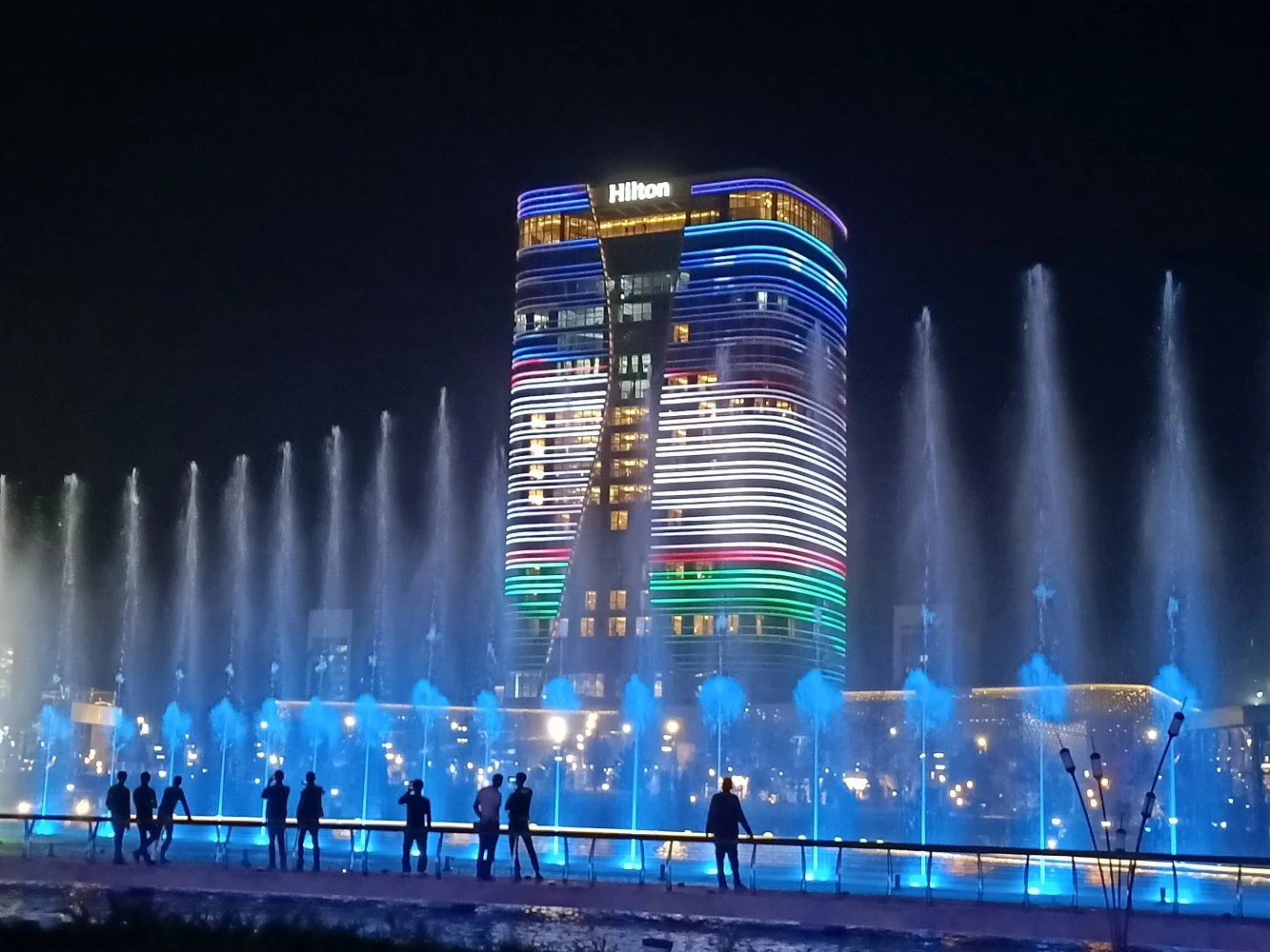 A large outdoor music and dancing water fountain show featuring laser lights, water screen mapping, video projections, fireworks