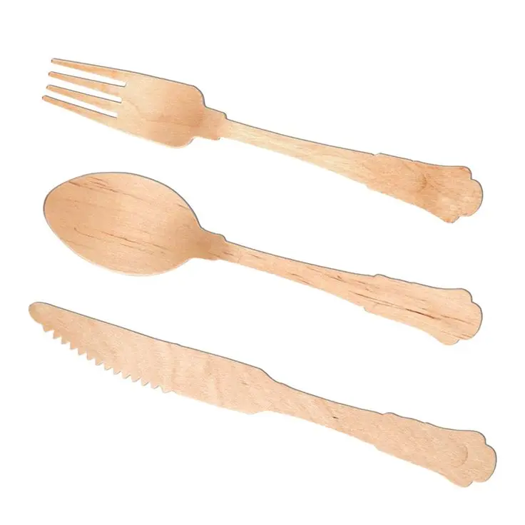 Disposable Wooden  forks Cutlery Set on a paper background with copy space  Wooden forks spoons and knives close up Wooden