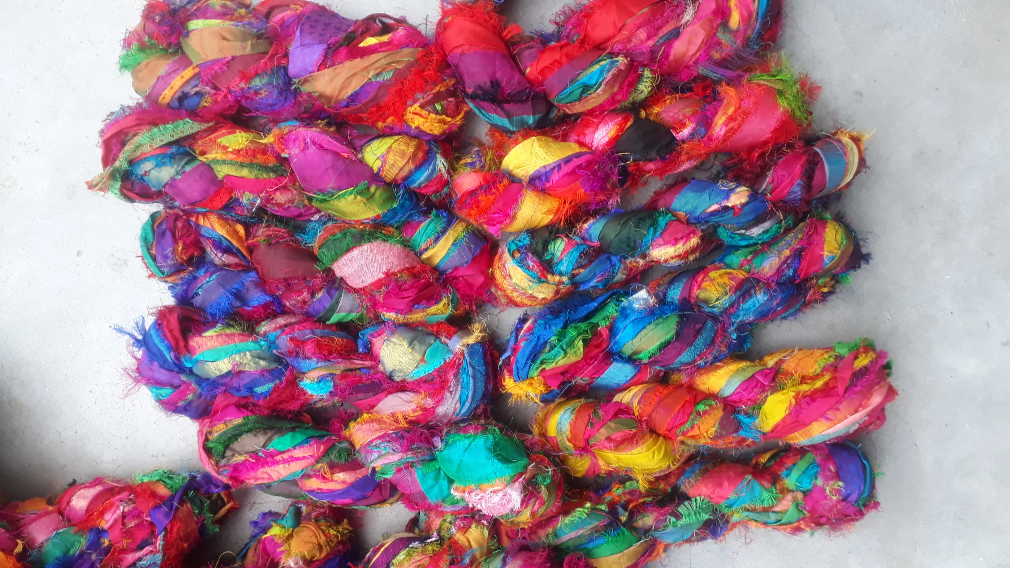 multi colored sari silk fuzzy  ribbon yarns made recycled sari fabrics ideal for textile artists and yarn stores for resale