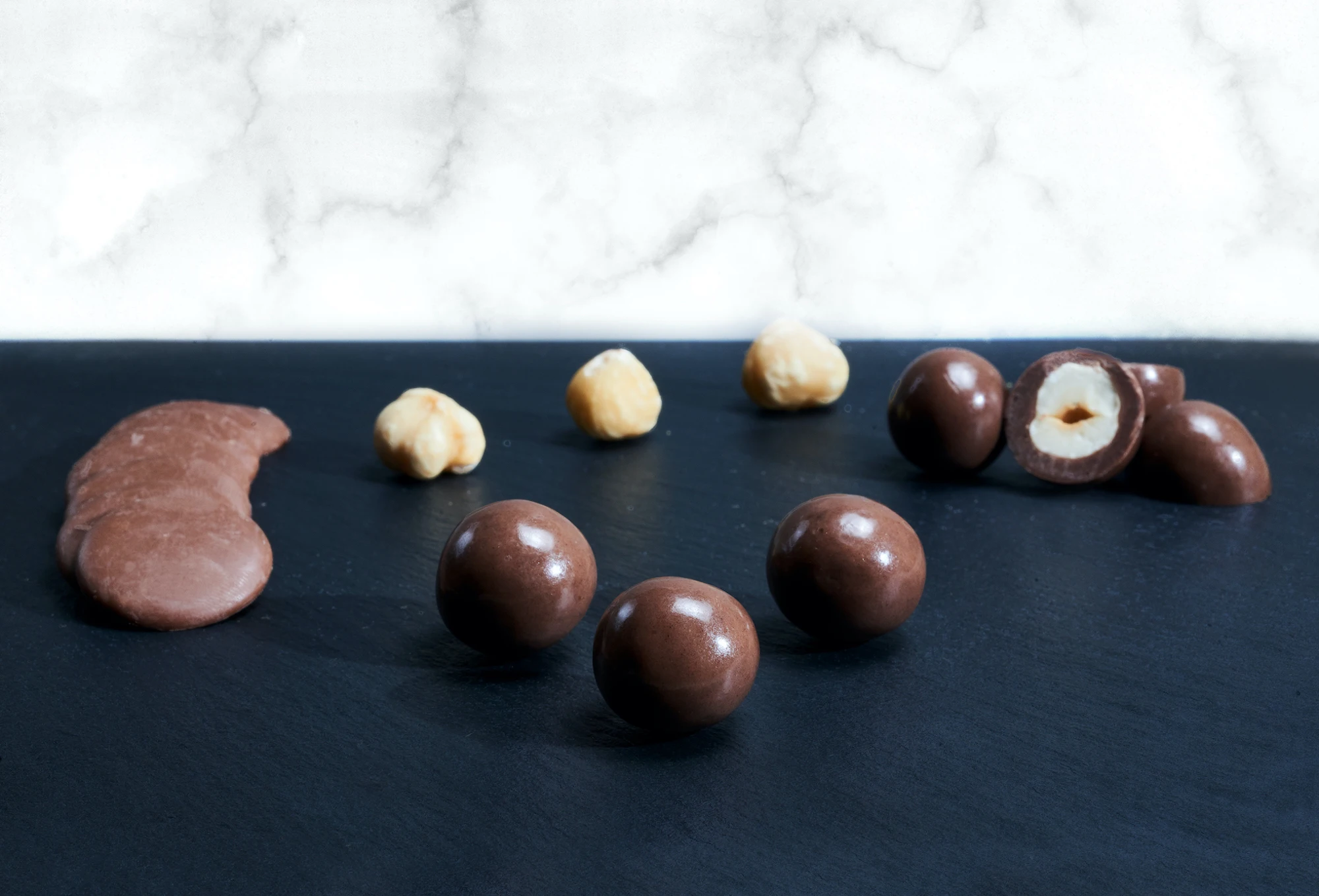 Superior quality roasted hazelnuts covered with milk chocolate in 1 kg ten-pieces box for b2b sales