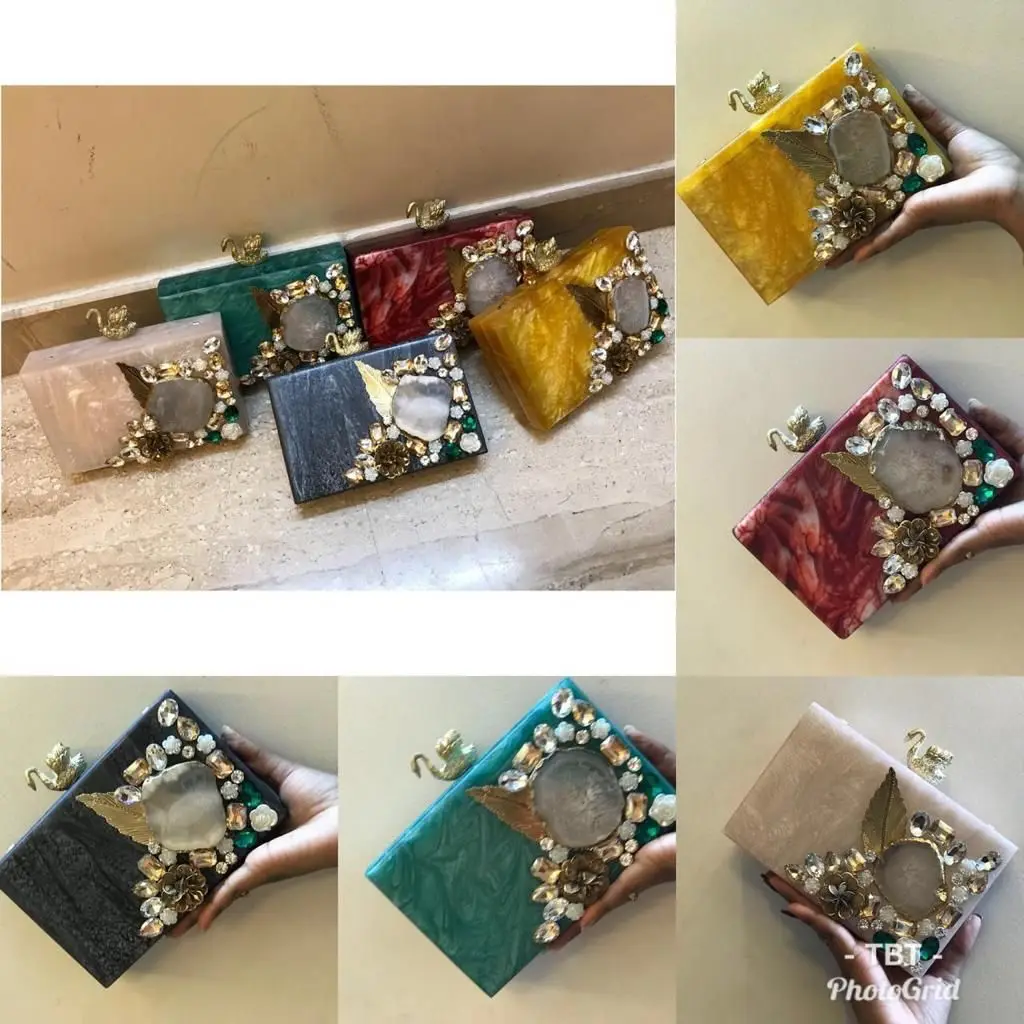 Featuring clutch in mother of pearl base with embedded rhinestones It has a gold chain sling, a magnetic closure.