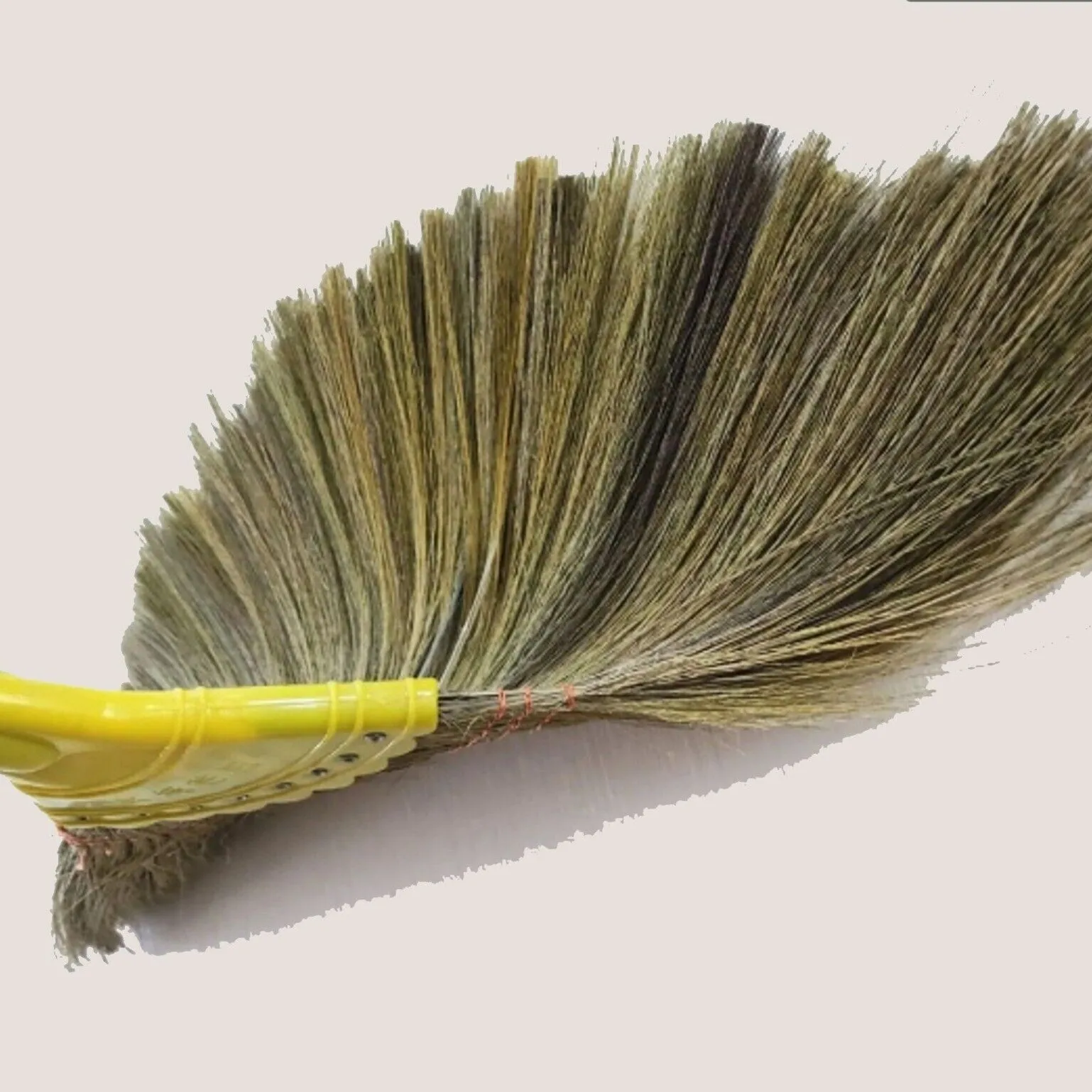 Small soft-bristled broom used to sweep dust in the house