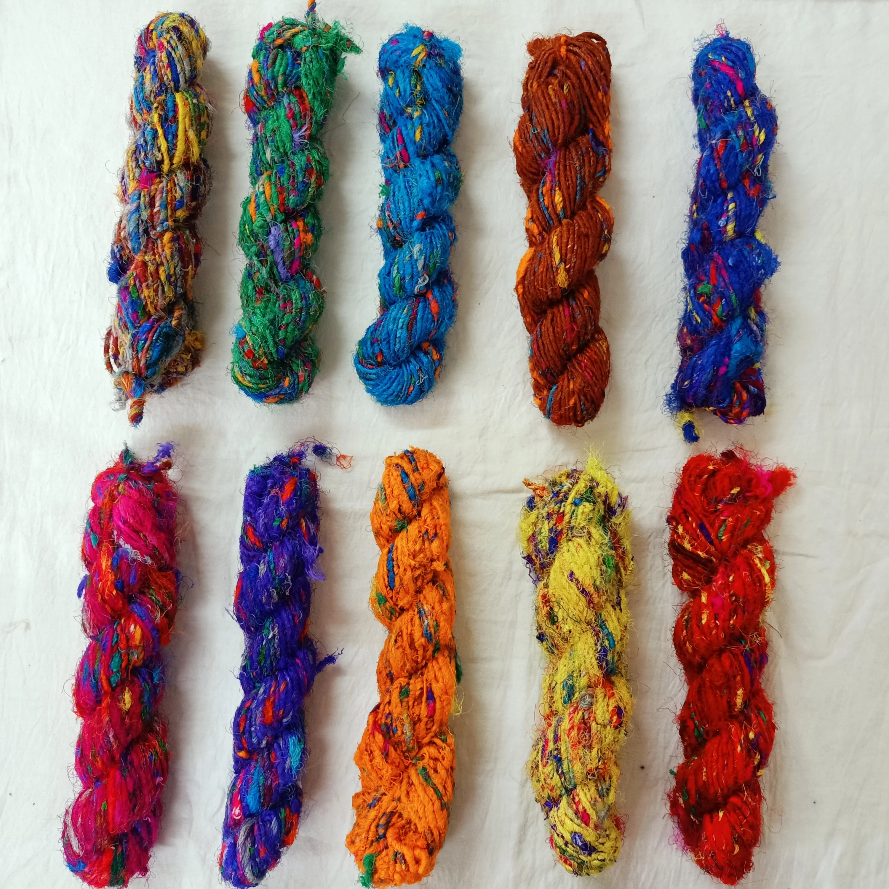 multi colored sari silk fuzzy  ribbon yarns made recycled sari fabrics ideal for textile artists and yarn stores for resale