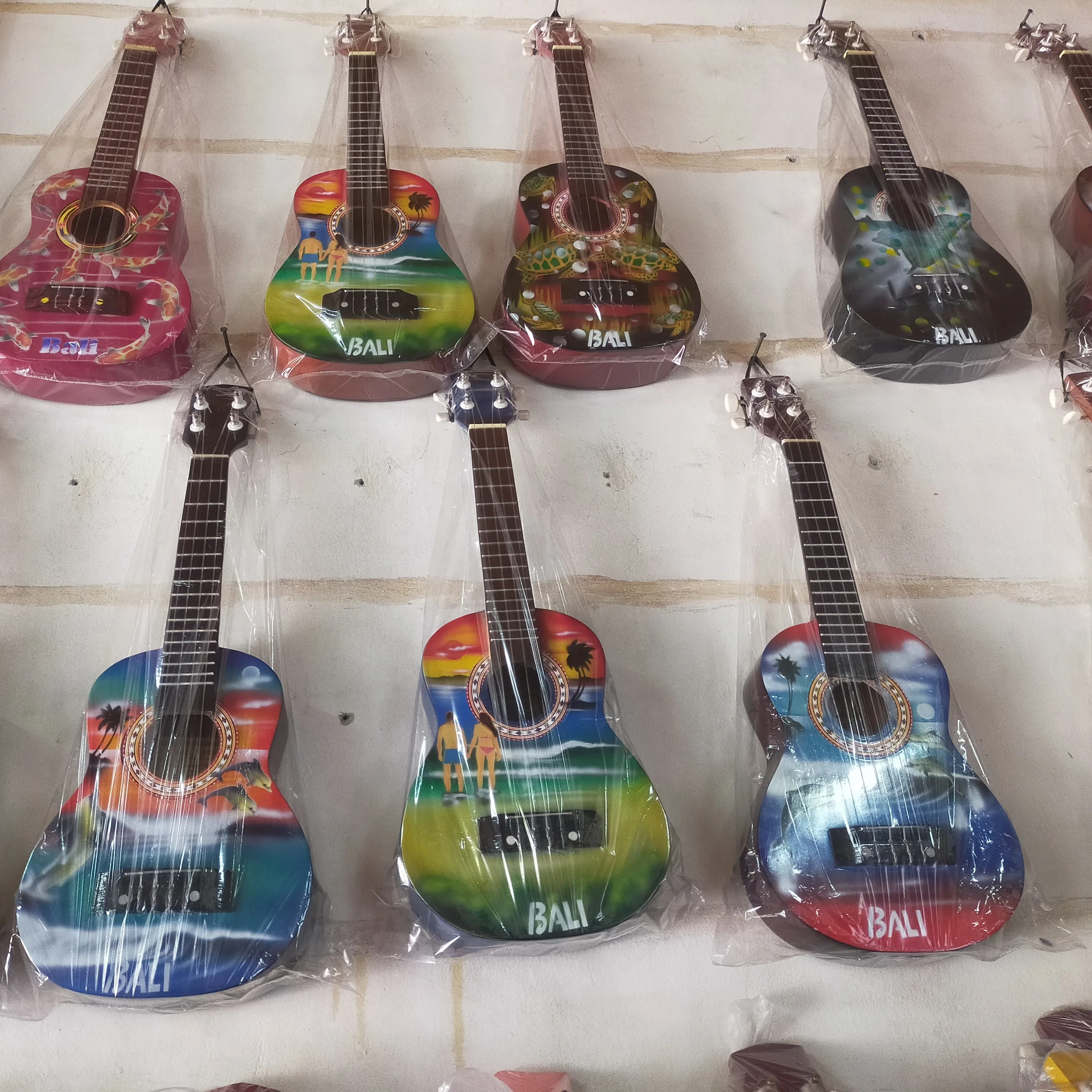 Nice product customized logo and design wholesale available in may colors wooden Bali cheap Ukulele