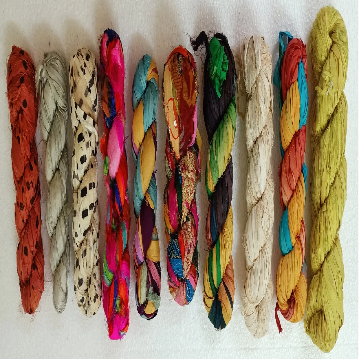 custom made natural and dyed banana an sari silk yarns made from recycled sari silk and banana silk fibers