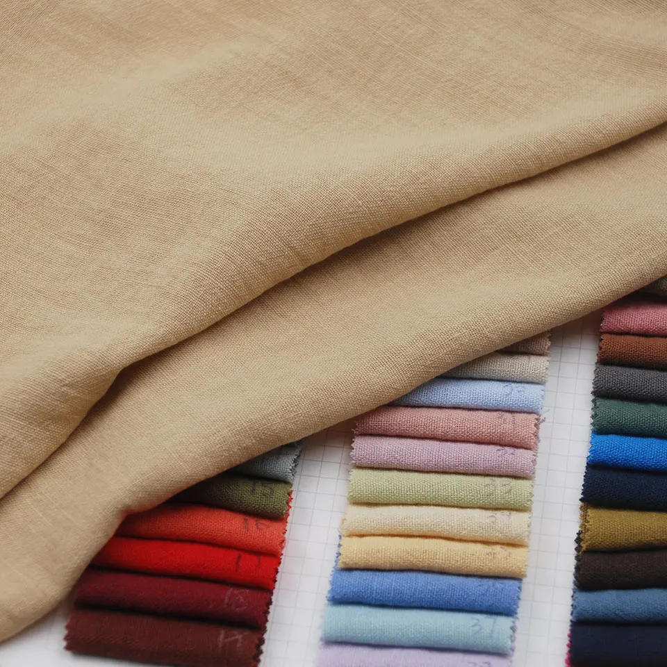 Low wholesale price soft solid slub pure color 100% polyester stone washed fake linen fabric