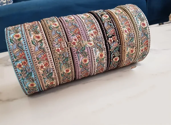 custom made machine embroidered ribbons & laces in various designs & colours for wedding dresses on net fabric with curly border