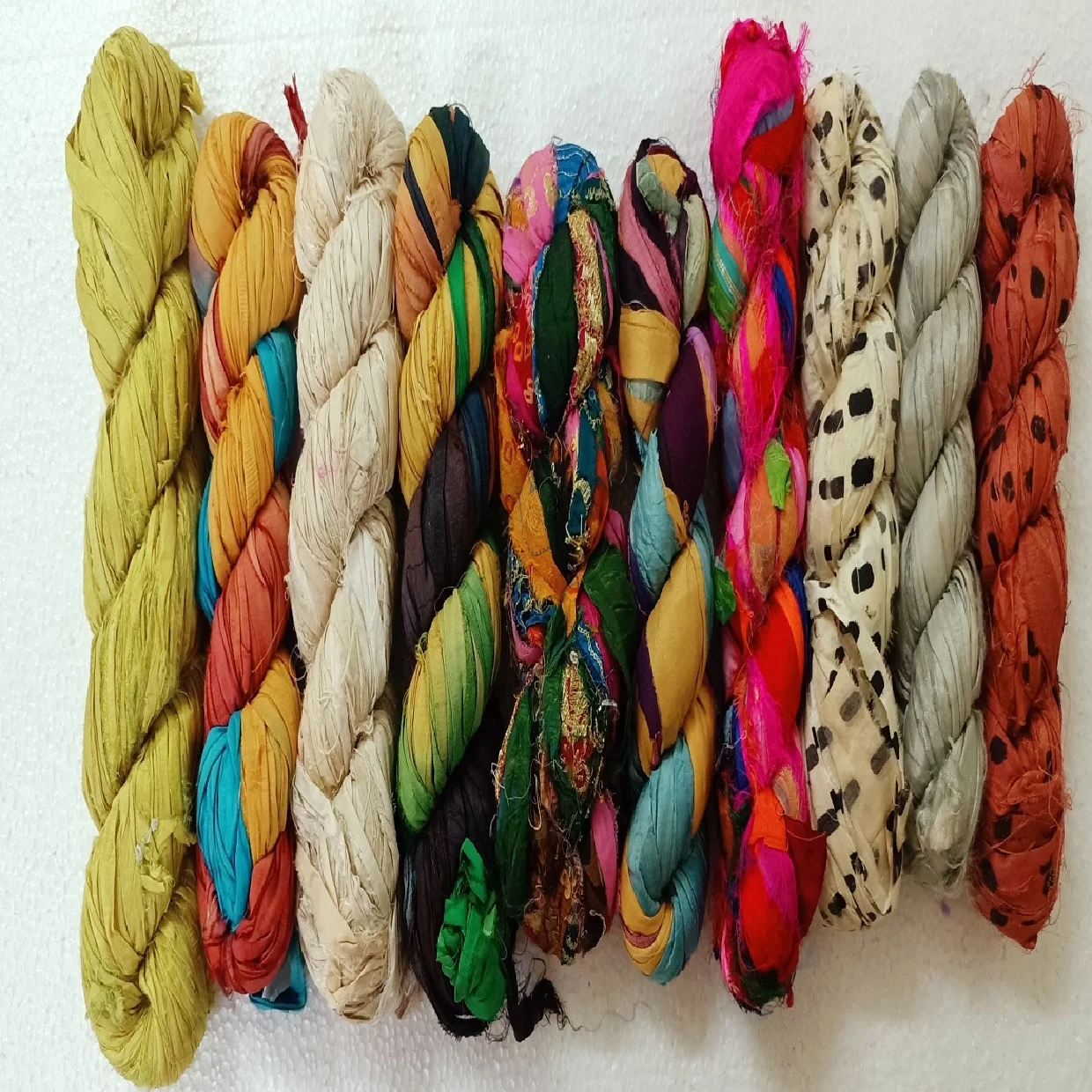 custom made natural and dyed banana an sari silk yarns made from recycled sari silk and banana silk fibers