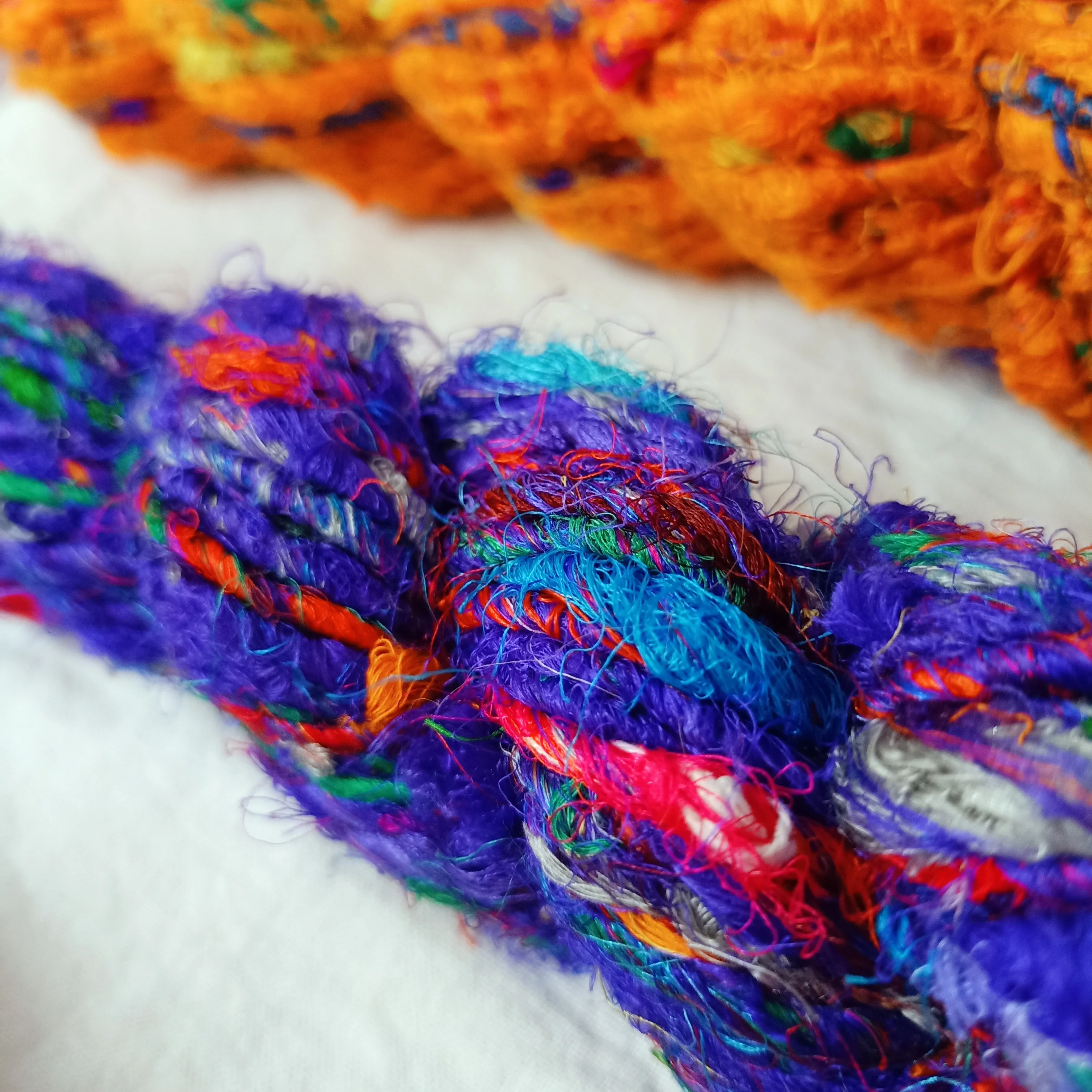 multi colored sari silk fuzzy  ribbon yarns made recycled sari fabrics ideal for textile artists and yarn stores for resale