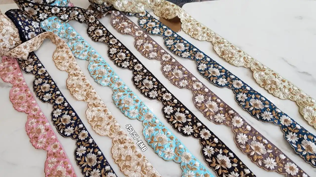 custom made machine embroidered ribbons & laces in various designs & colours for wedding dresses on net fabric with curly border