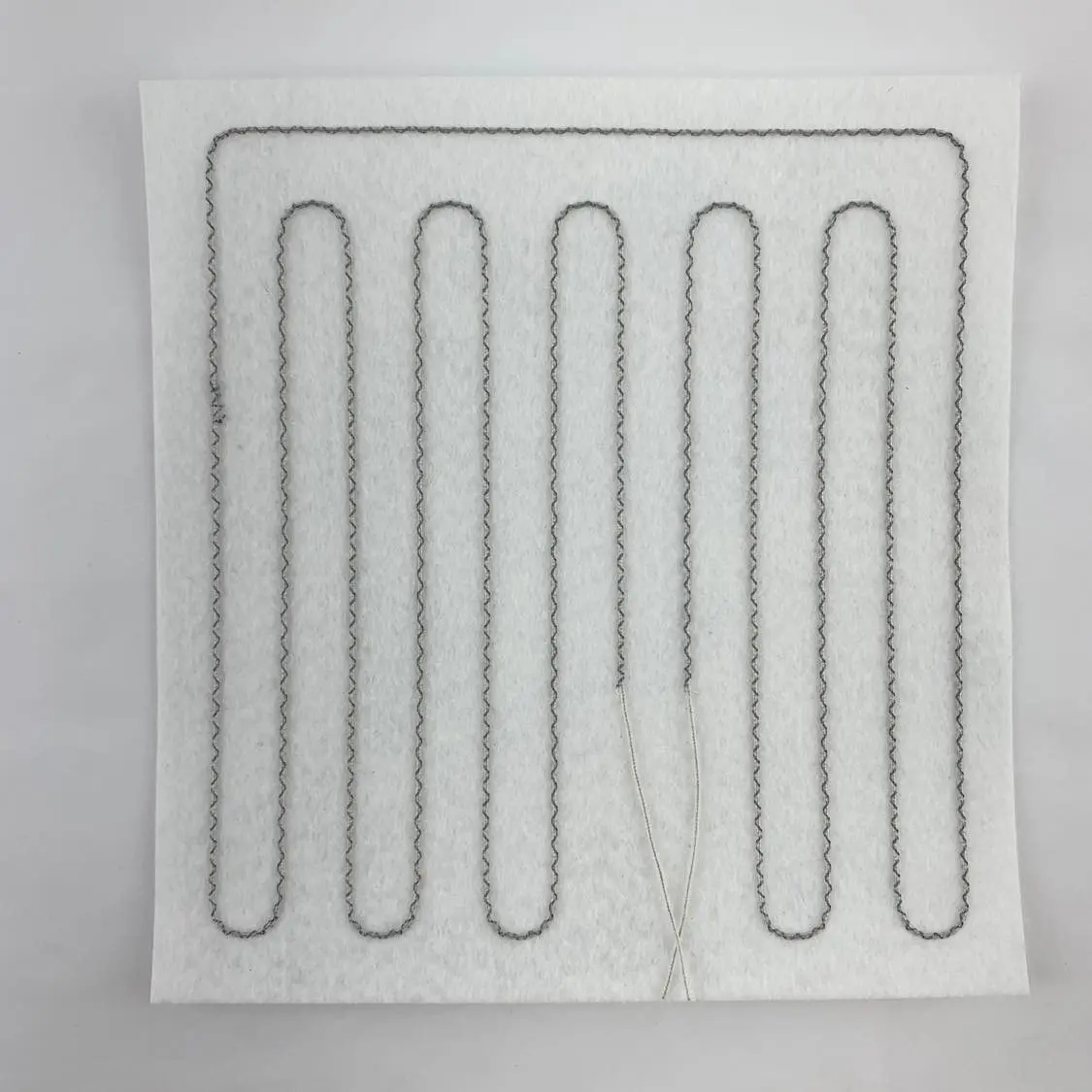 DC powered heating pad layer for jacket