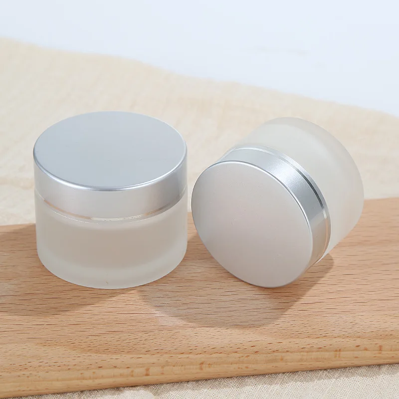 Wholesale 30g 50g 1oz Empty Luxury Eco Friendly Face Eye Body Frosted Clear Glass Cosmetic Jar with Gold Black Sliver Lids