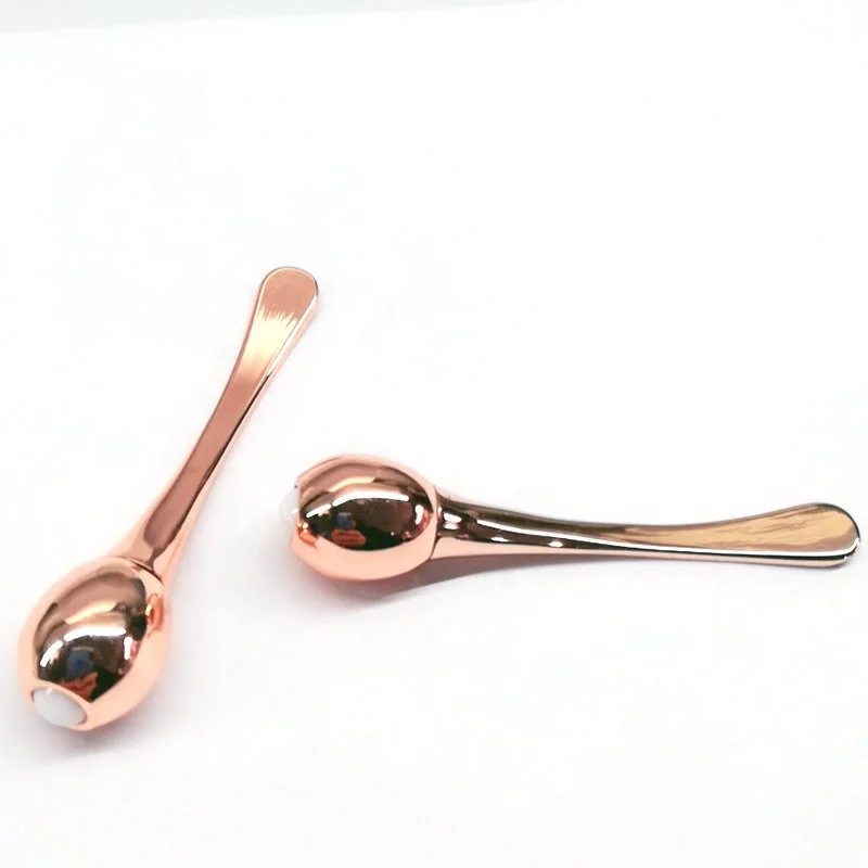 Luxury golden metal spatula in cosmetic along with skincare cream jars