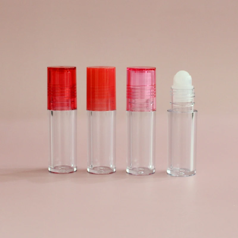 Low moq high quality round clear pink top thick wall lip oil tube  container cosmetic lip gloss packaging roll on lip gloss