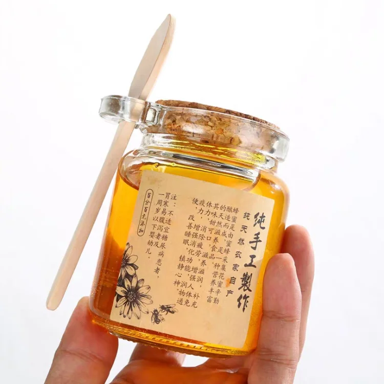 Manufacture wholesale 250 ml clear glass jar sealed glass bottle with cork and wood spoon for honey kitchen storage container