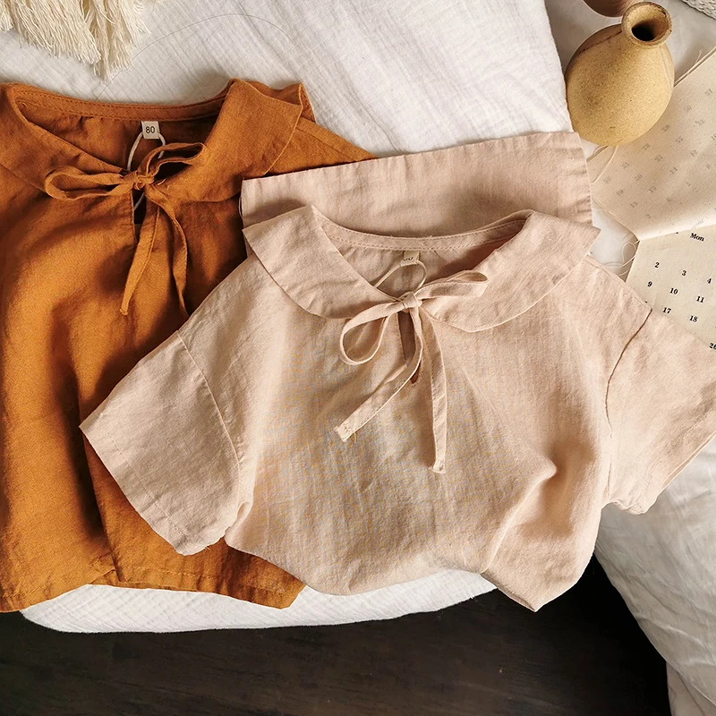 
The new style of solid color shirts for children and girls in summer, fashionable loose-fitting ruffled shirts, Korean style shi 