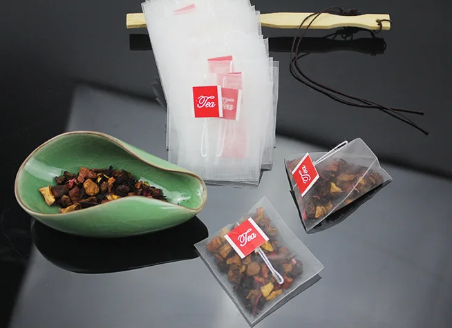 Disposable triangle nylon pyramid tea bags wholesale price tea bag with custom string