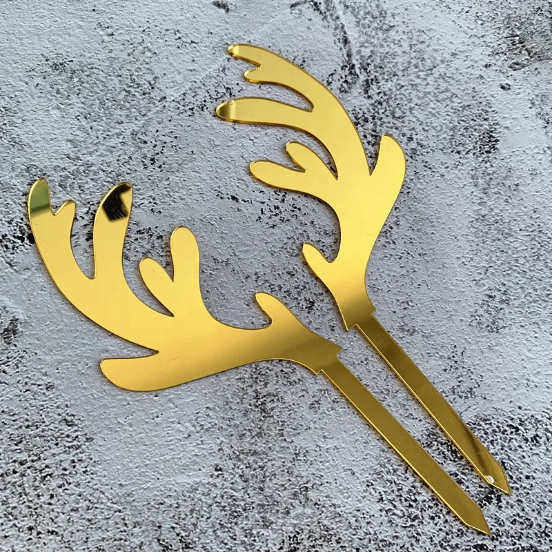 A pair of gold elk acrylic Christmas cake topper for cake decoration