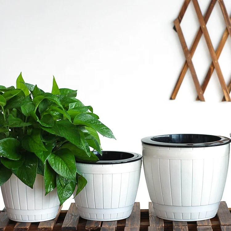 Self watering plastic flower plant pot for indoor