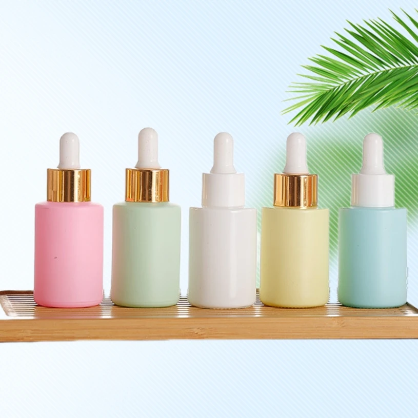 Hot sale pink flat shoulder 30ml plastic head dropper oil bottle Macaron color cosmetic glass dispenser empty bottle