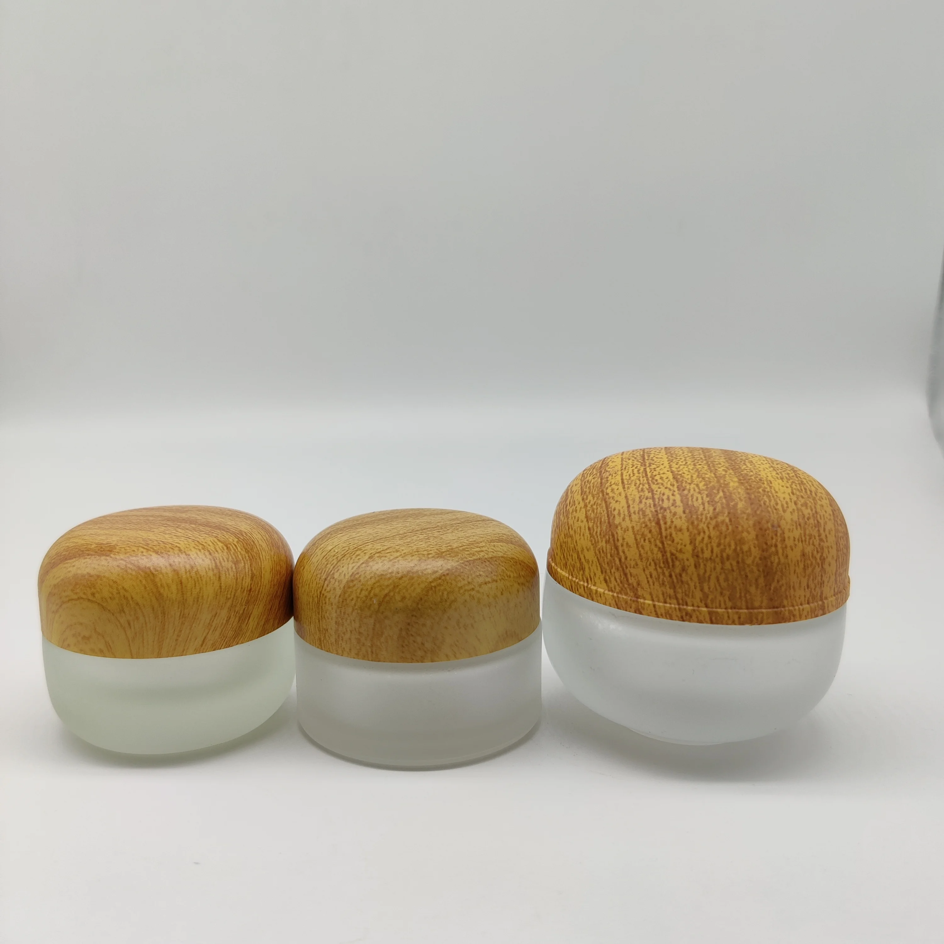 Factory hot sell cosmetic packaging 50ml frosted clear glass jar with bamboo lid