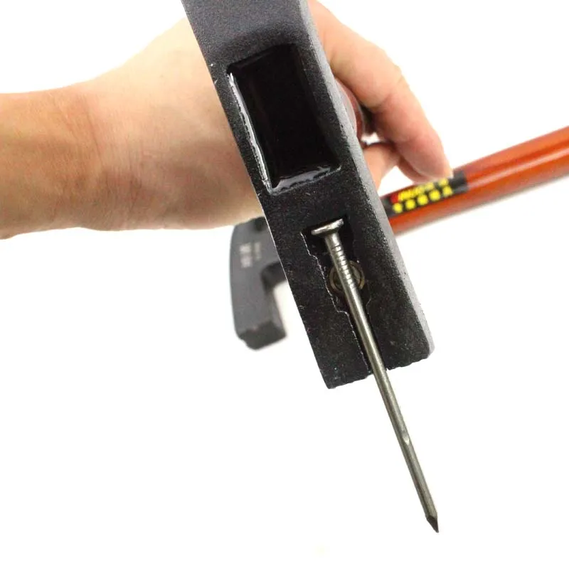 A hammer with a wooden handle that lifts nails