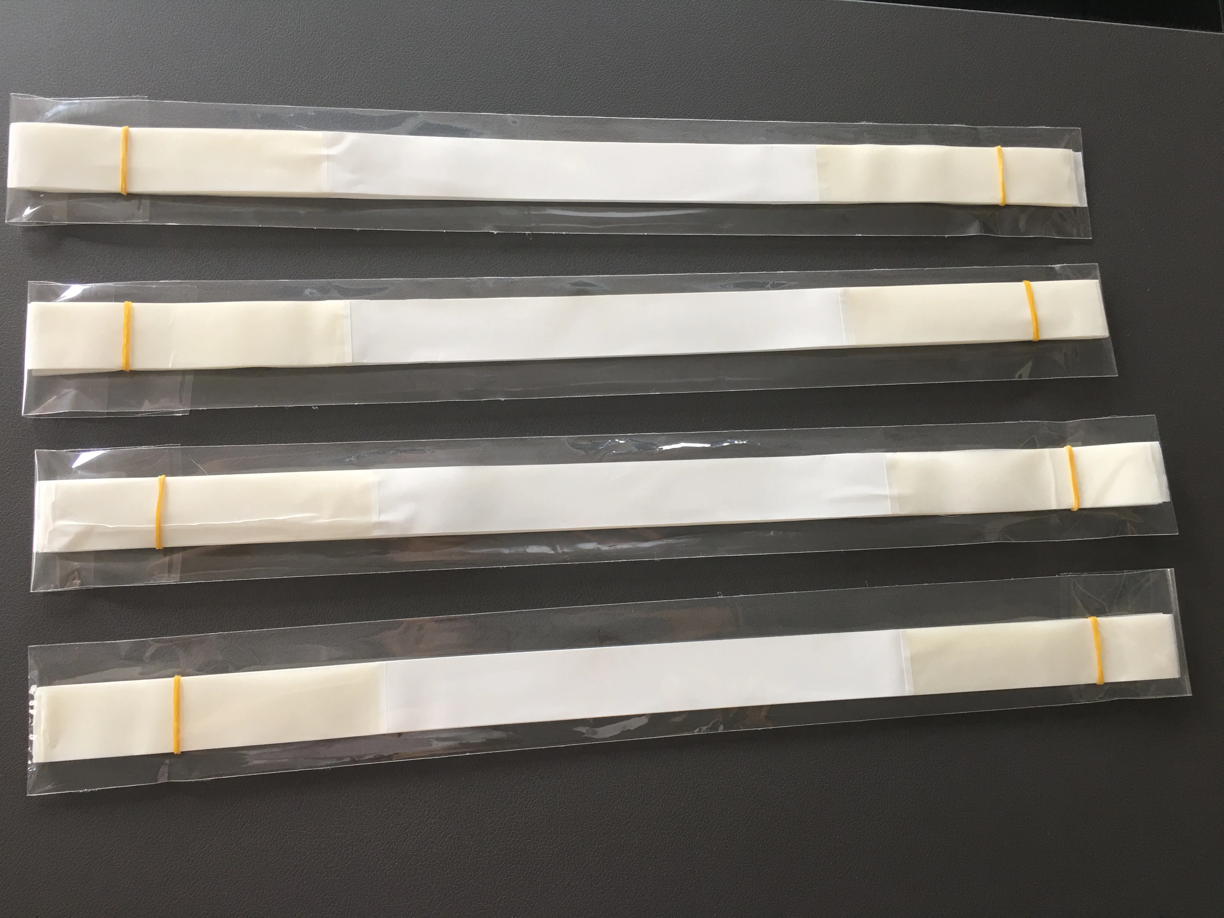 sturdy white plastic strips with high tack adhesive on each end are convenient for all packages packed 25 pieces per PE bags