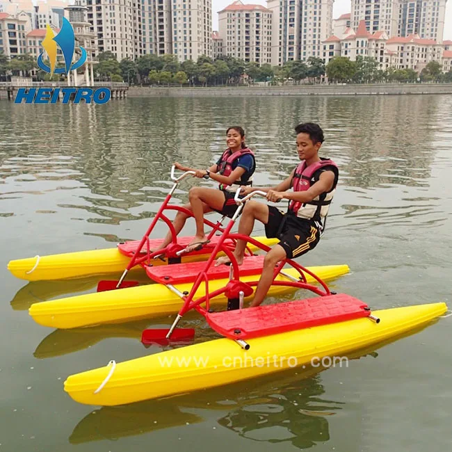floating boat able to cycle on water mounted on two floats, recreational and competitive activity using water bike