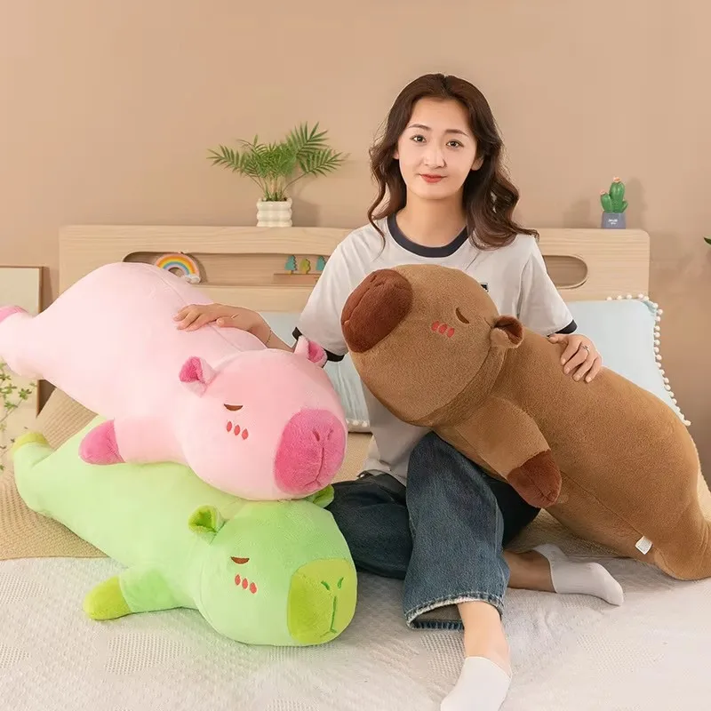 The capybara pulls the pillow for girls to sleep on the bed and holds the sleeping doll long pillow plush toy