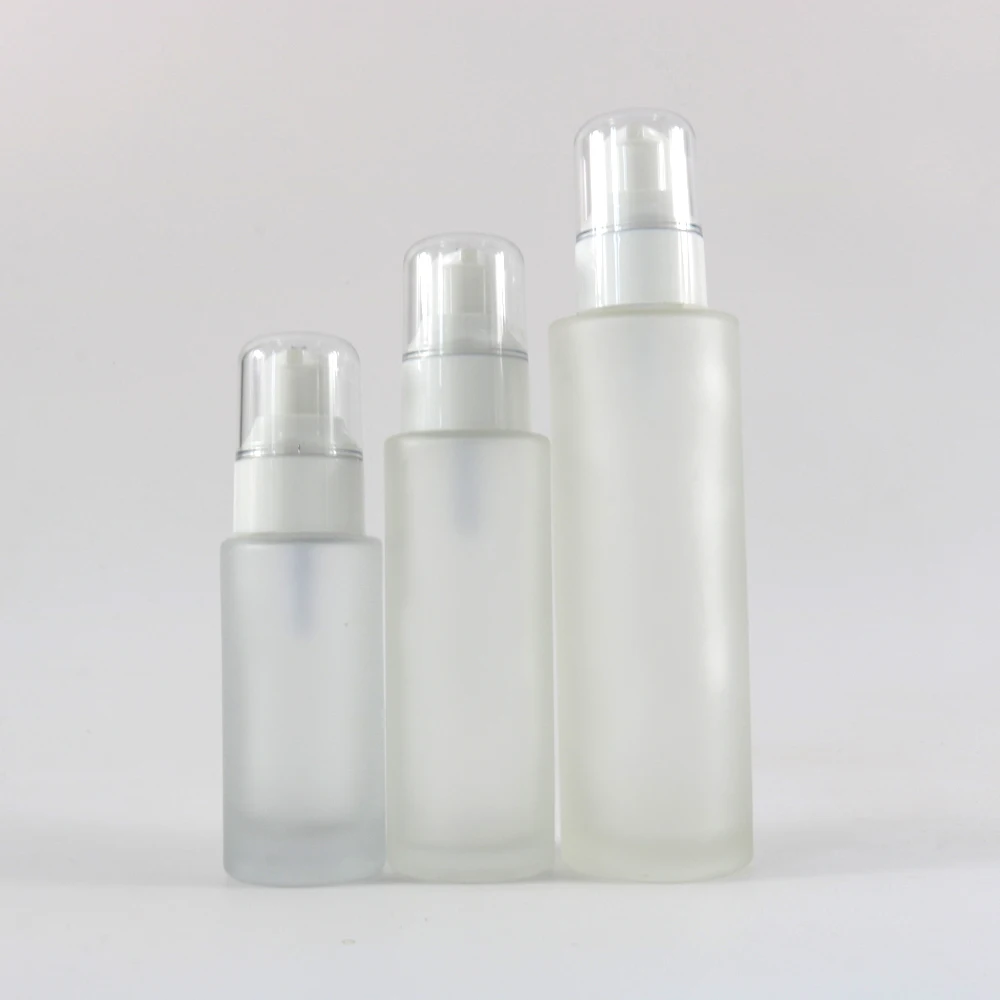 Cosmetic clear frosted glass flat shoulder bottle with white white pump