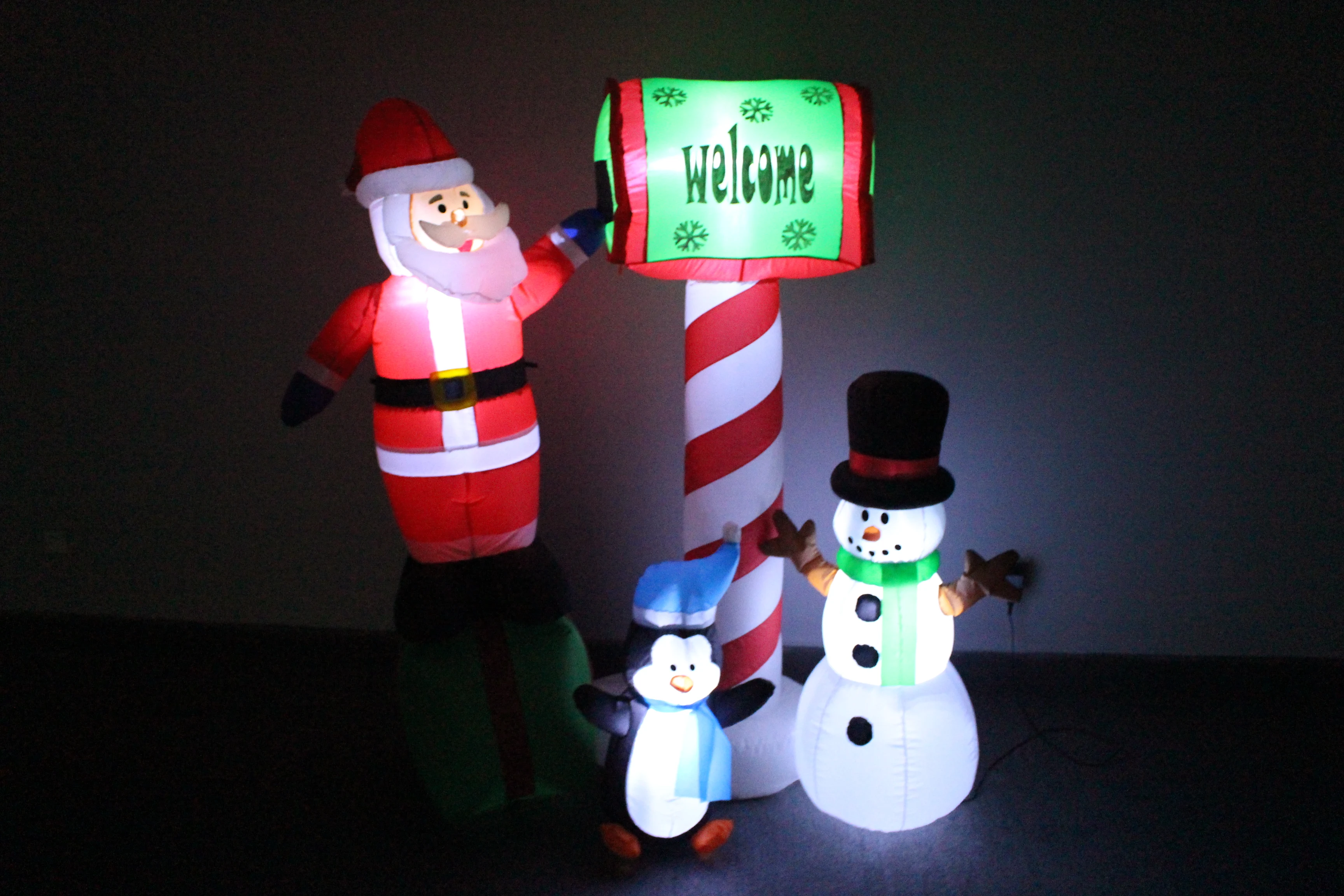 
150cm/5ft inflatable santa claus sitting on a gift bag touching the mailbox with a penguin and snowman in the front 