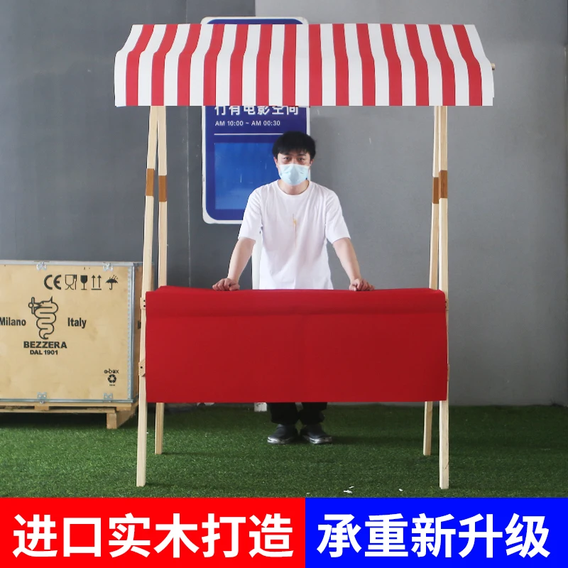 Wooden market stand stall with orange white striped awning retail business concept