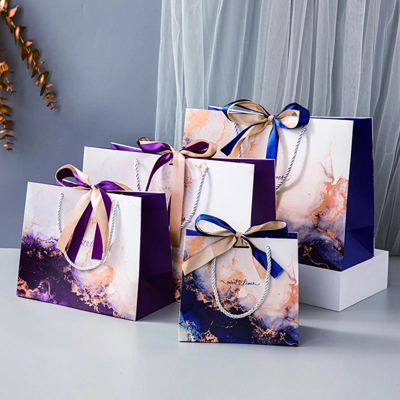 Wholesale Luxury Bulk Square Bottom White Cardboard Offset Printing Clothing Jewelry Paper Gift Bags with Ribbon Bow and Handles