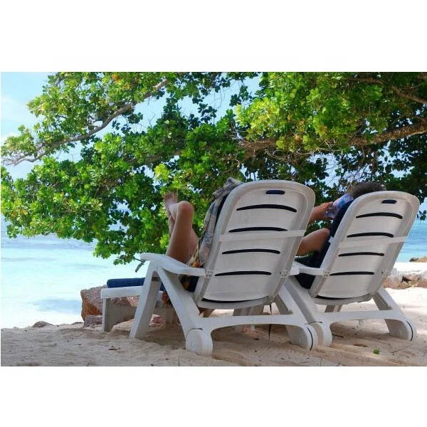 Outdoor beach hotel swimming pool plastic chaise lounge chair