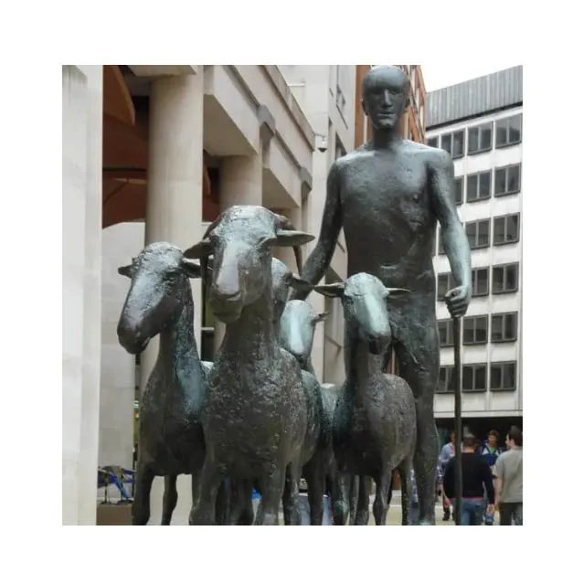 Bronze figure and goats sculpture statue on a square after rain next to cafe London in United Kingdom