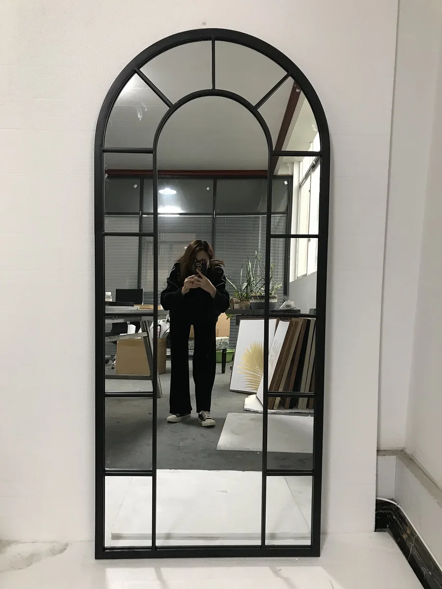 large arched full-length metal floor standing dressing mirror