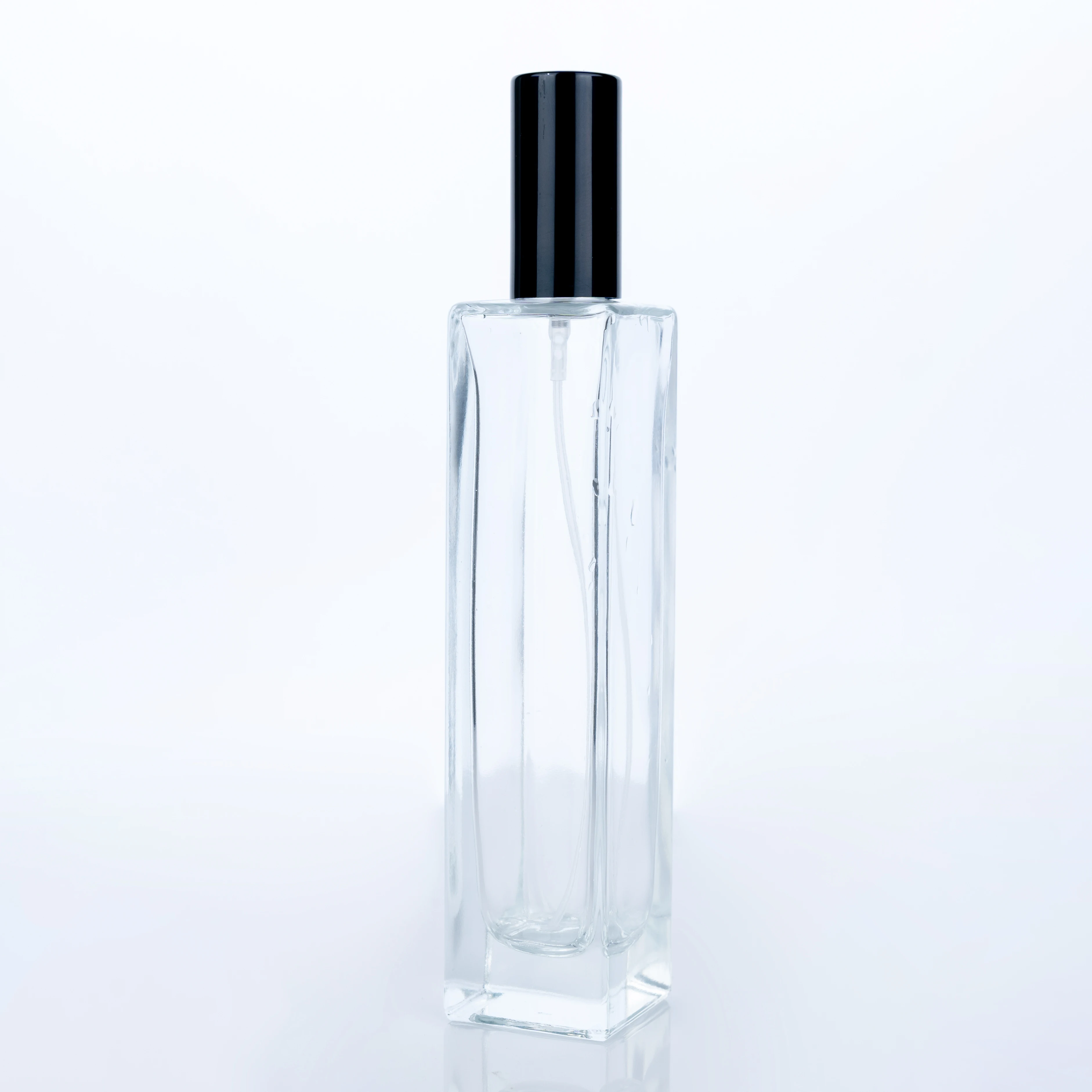
The Customized High Quality 100ml Transparent Bottle With Black Round Cap Square Tall Perfume Bottle 