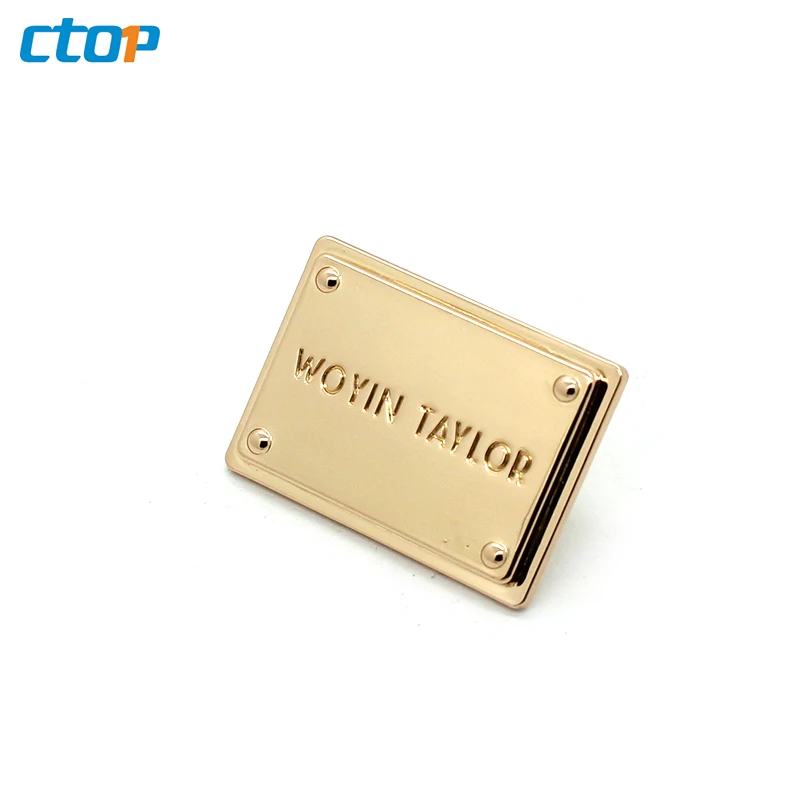 Wholesale standard environmental custom embossed metal logo plate bags metal labels for clothing