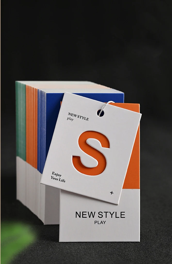 Simplified Letter Hollowed Out Process Embossed Paper Clothing Tag Design Clothing Label Color Printing Clothing Tag
