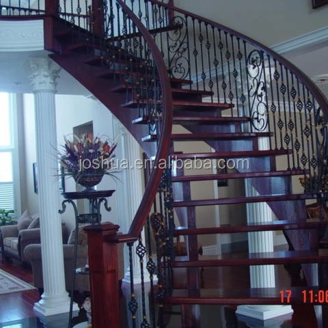 wood curved staircases with Wrought-iron balusters