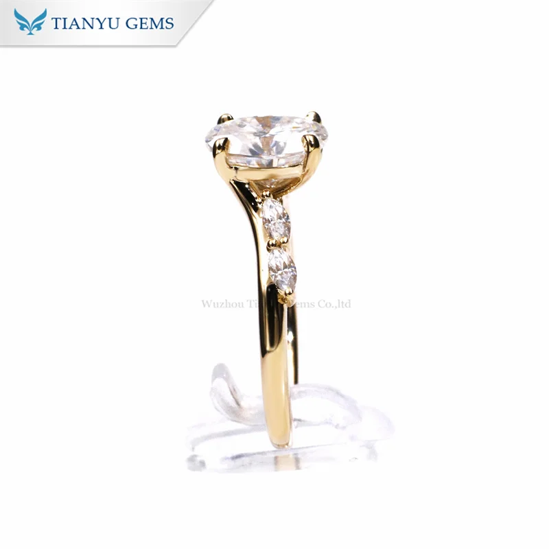 Tianyu gems yellow gold Oval centre diamond with Marquise cut stones on the shoulders engagement ring